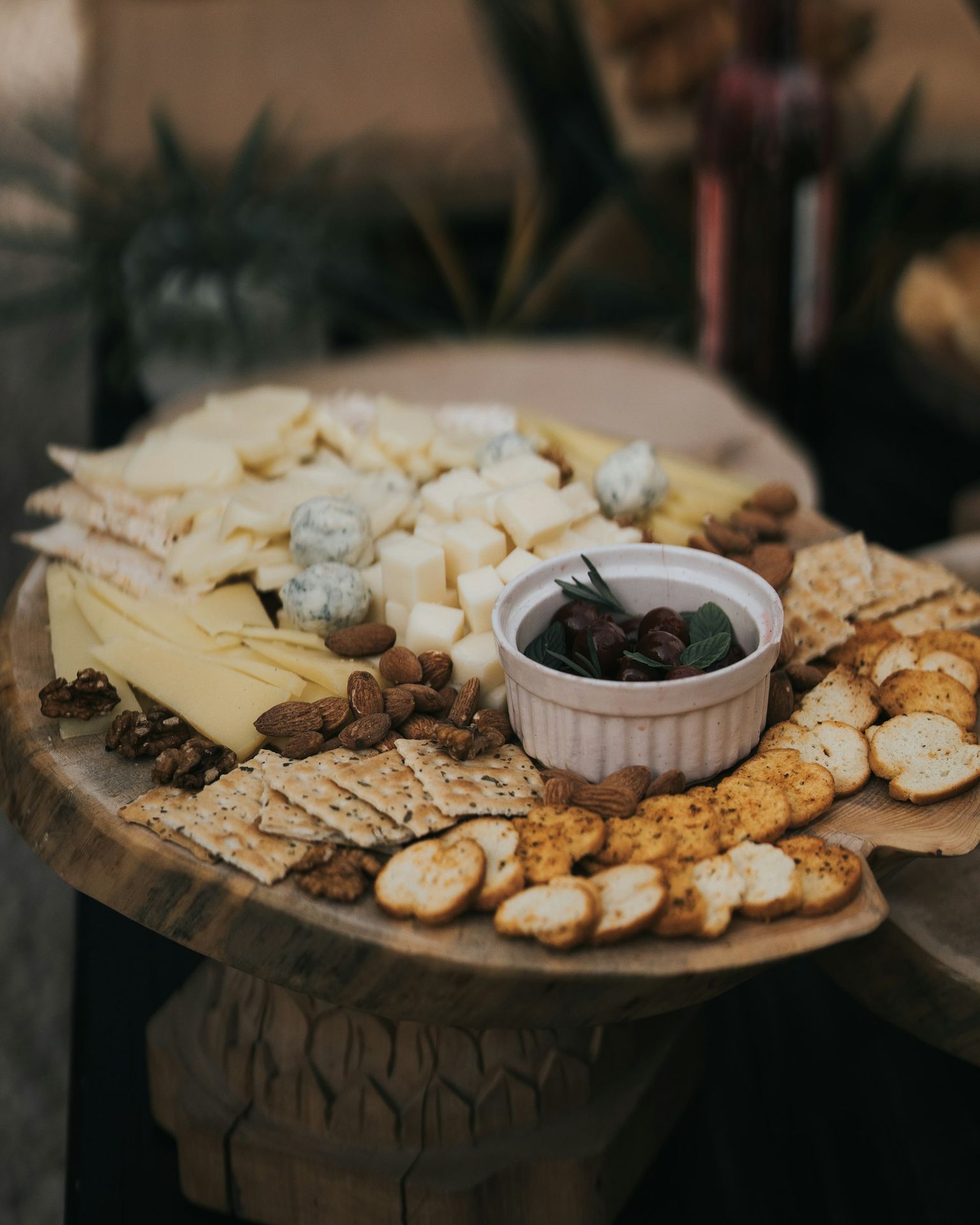 A platter of cheese and crackers on a table
